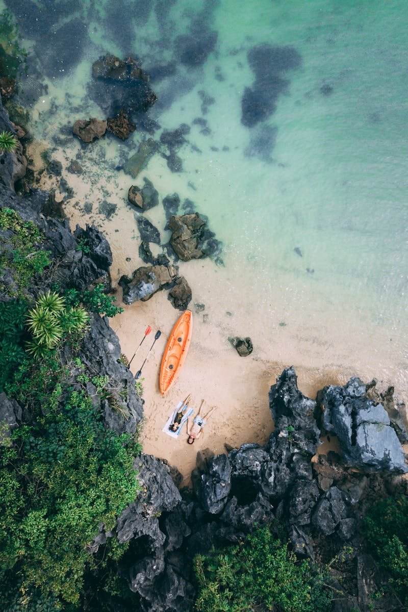 Captivating aerial shot of a serene beach with a kayak in Vietnam.